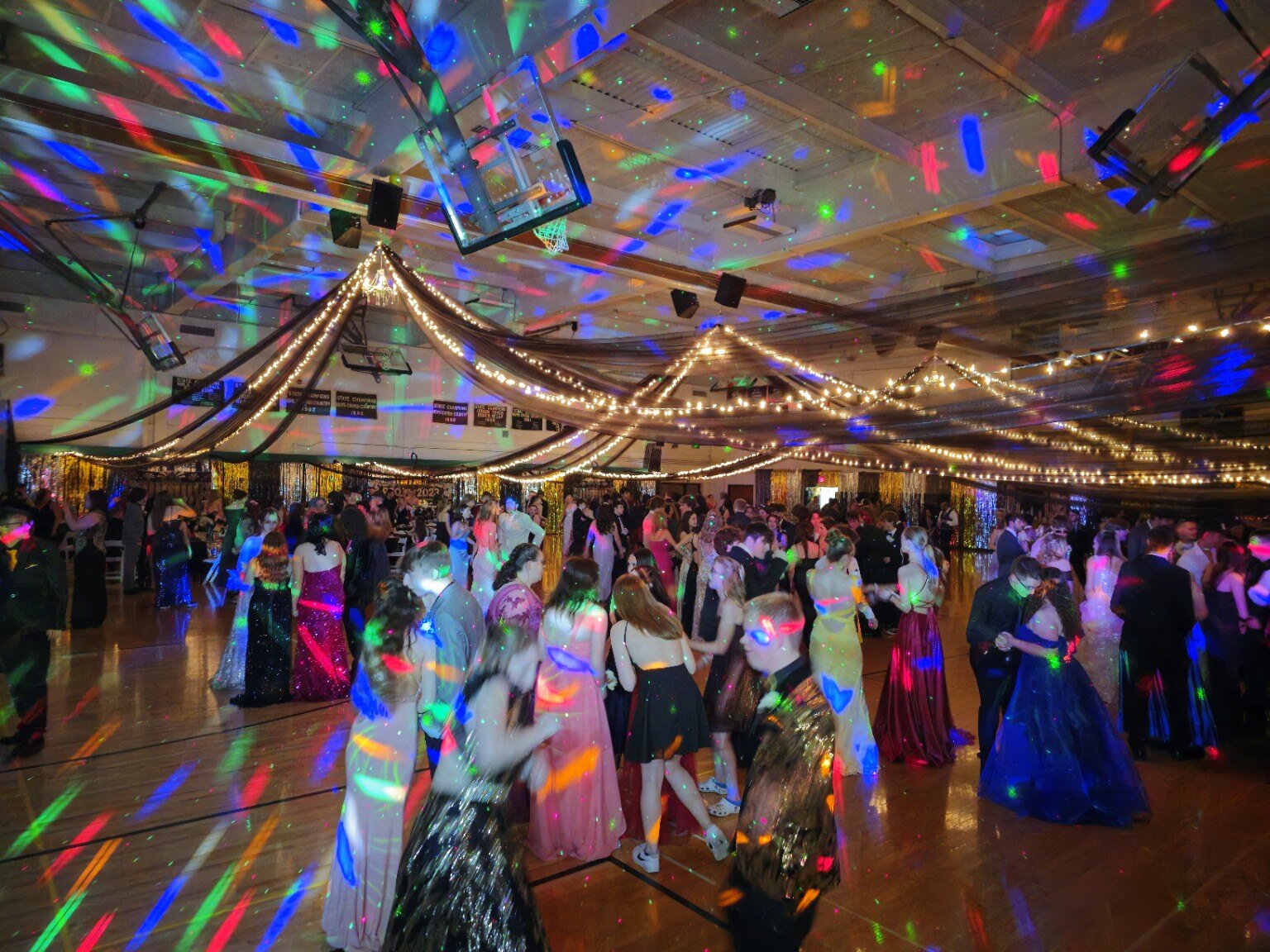 Packed dance floor under colorful lighting